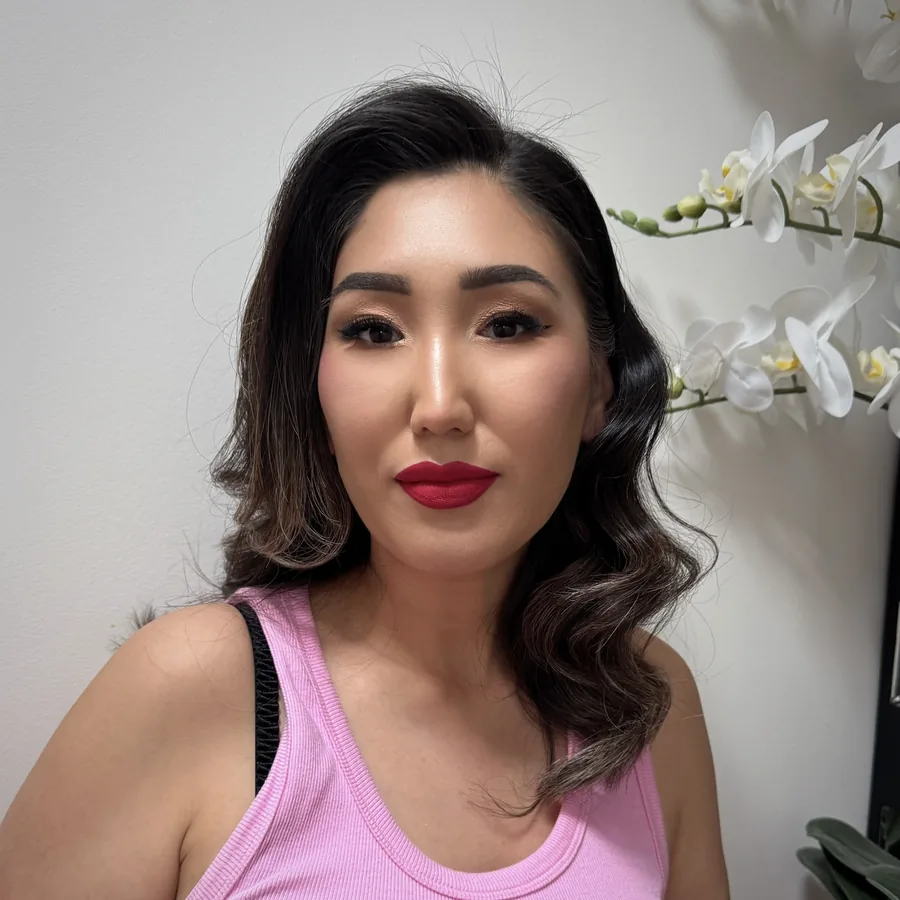 Red lip and soft waves, makeup done in the Middle Park studio