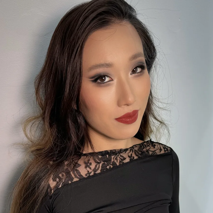 Evening makeup with a defined smoky eye and a red lip, side view