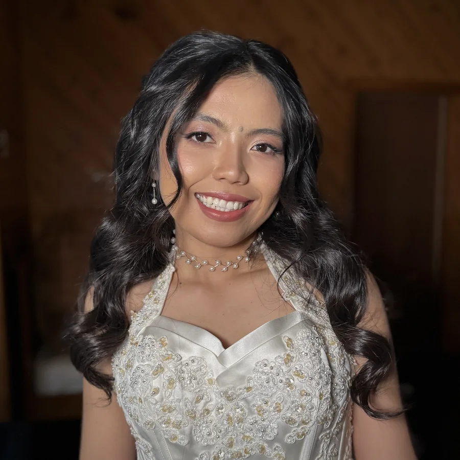 Wedding makeup with soft curls and a fresh skin finish, close portrait