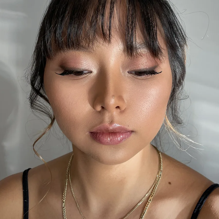 Liner drawn to suit the eye shape, glossy lip and a soft fringe