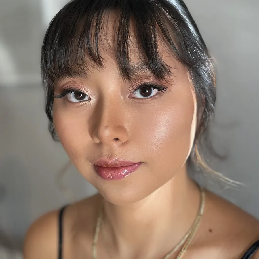 Glossy nude lip and lifted lashes worn with a fringe, skin left fresh