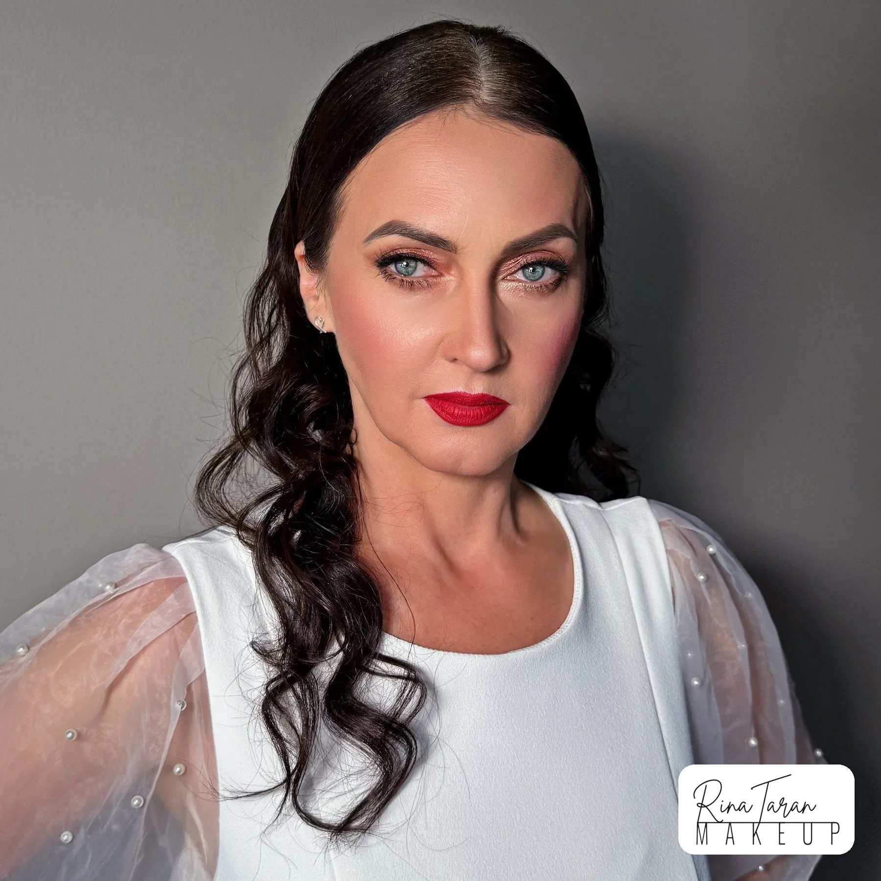 Dark-haired bride with a red lip and a clean, defined eye