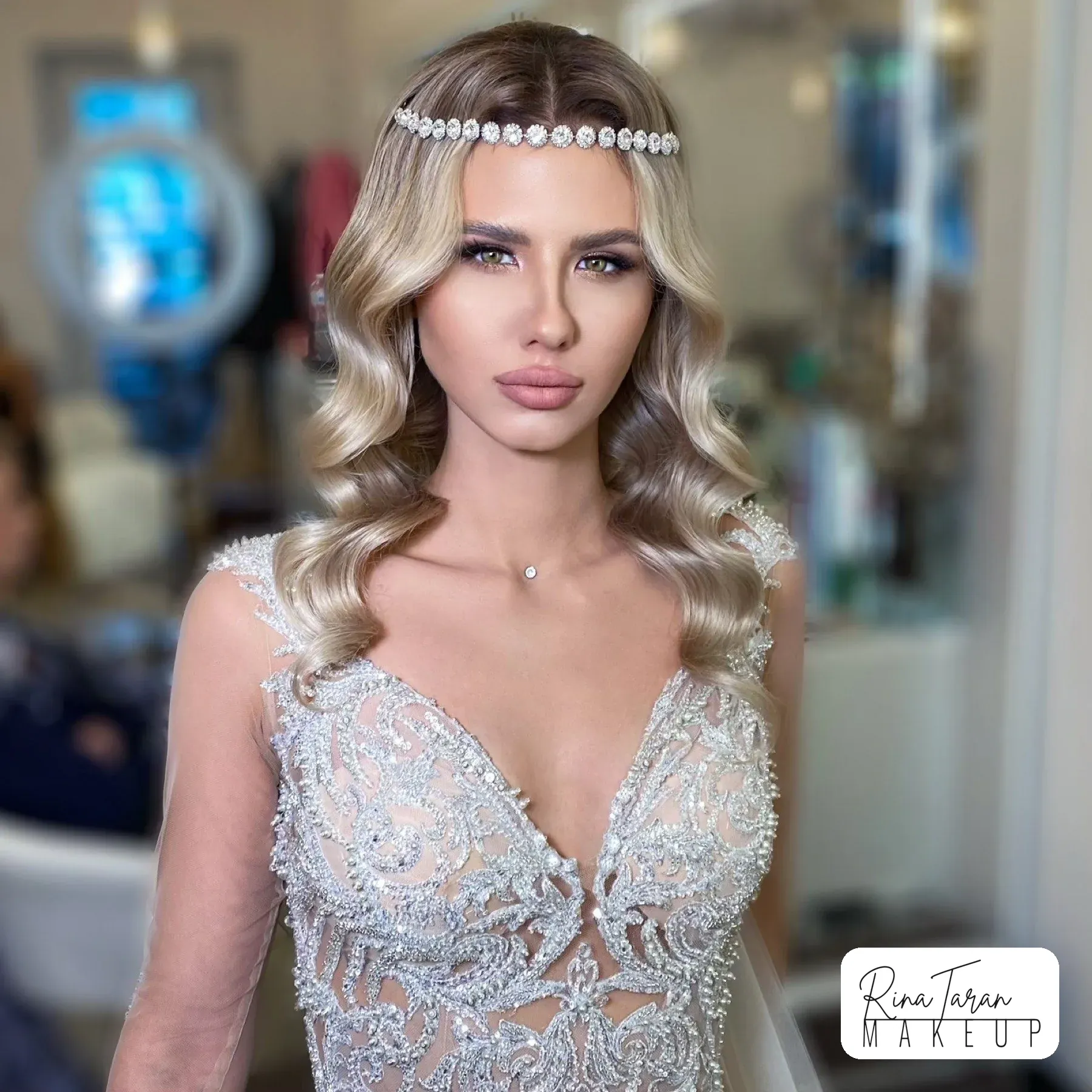 Softly smoked eye and a nude lip on blonde hair, with a pearl headband