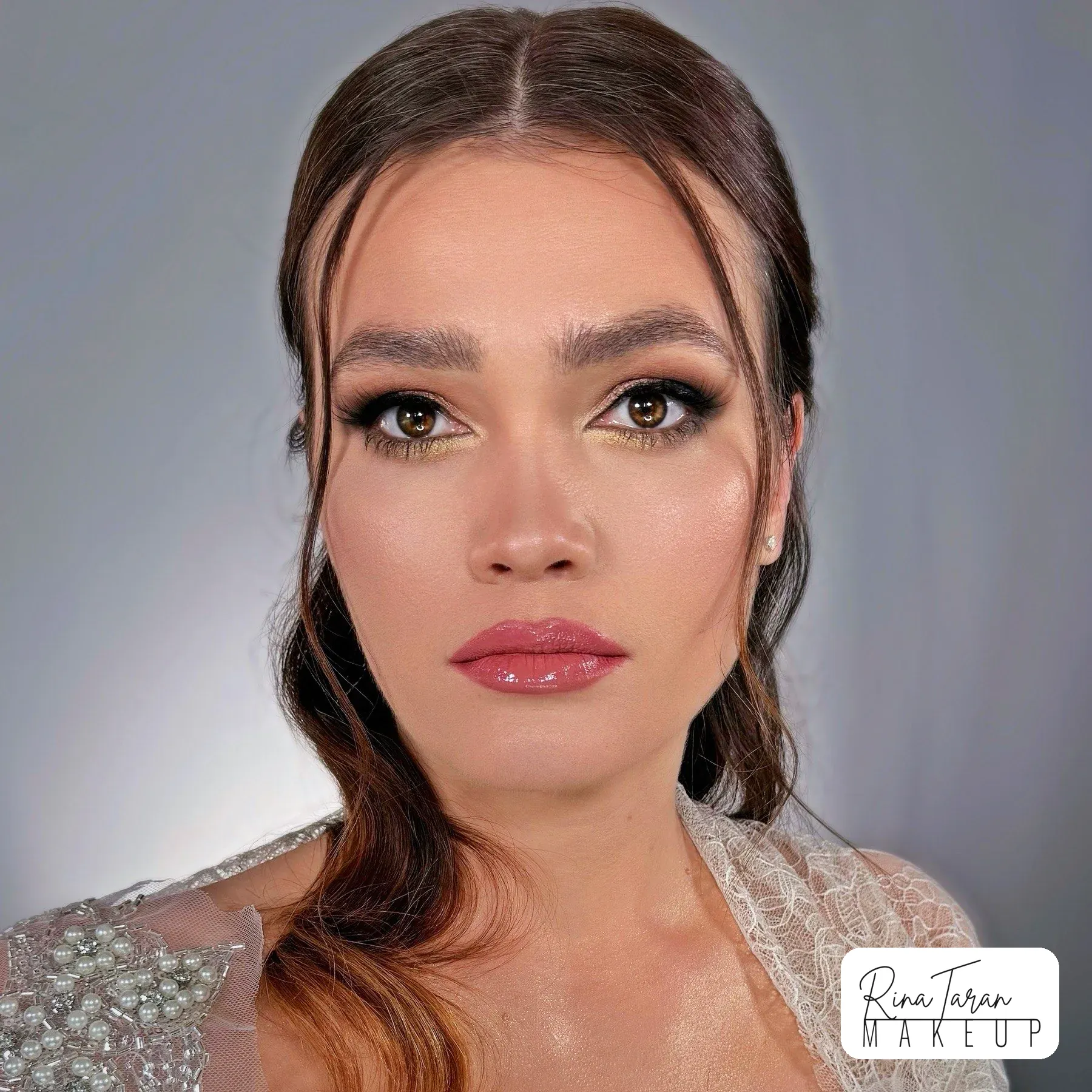 Glossy berry lip with a defined brow and sculpted cheekbones