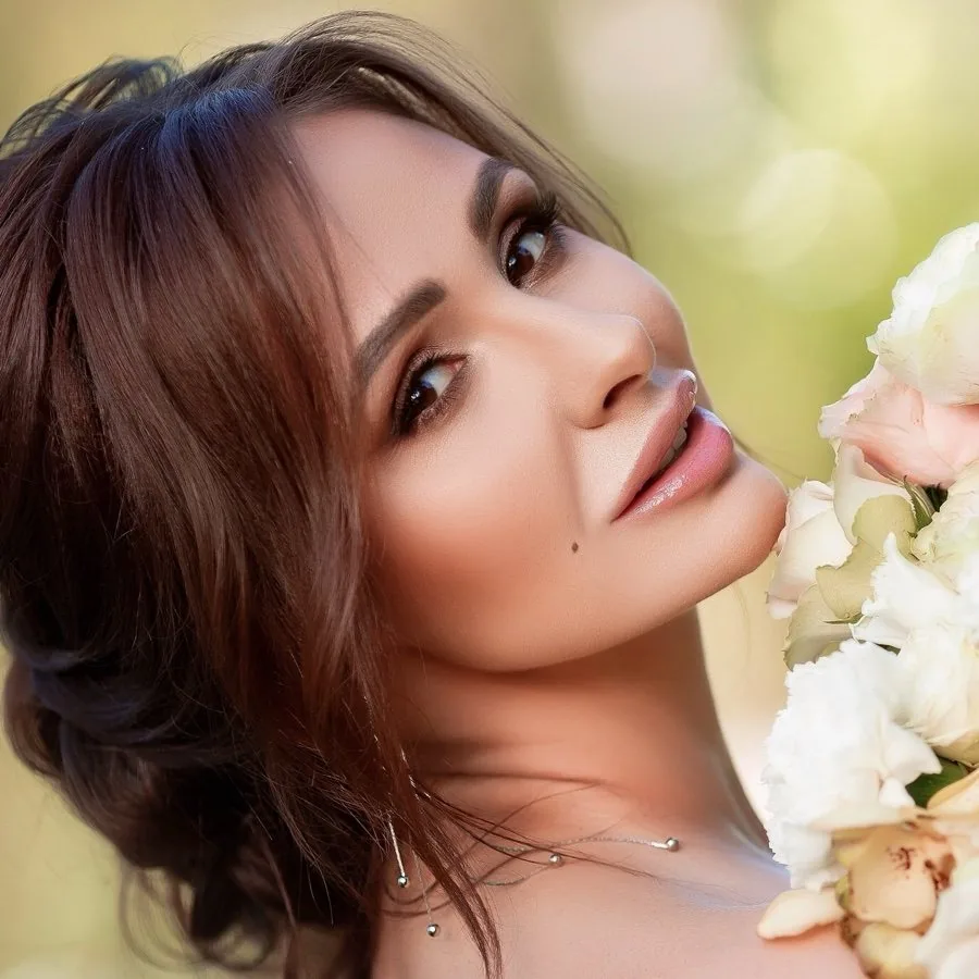 Bridal makeup in Melbourne: soft warm eye, glowing skin and a low bun with white roses