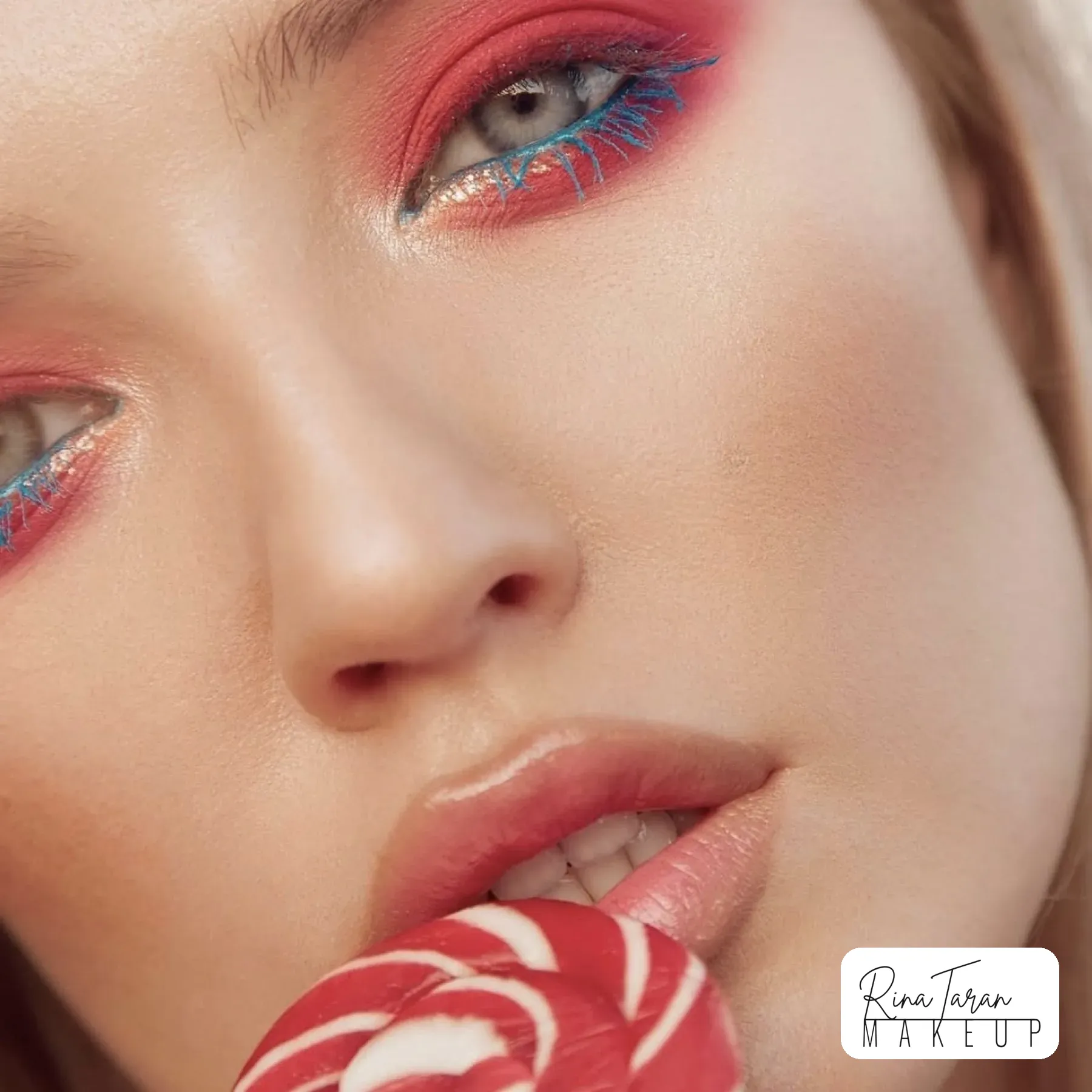Beauty editorial close-up: coral graphic eye with blue mascara on the lashes