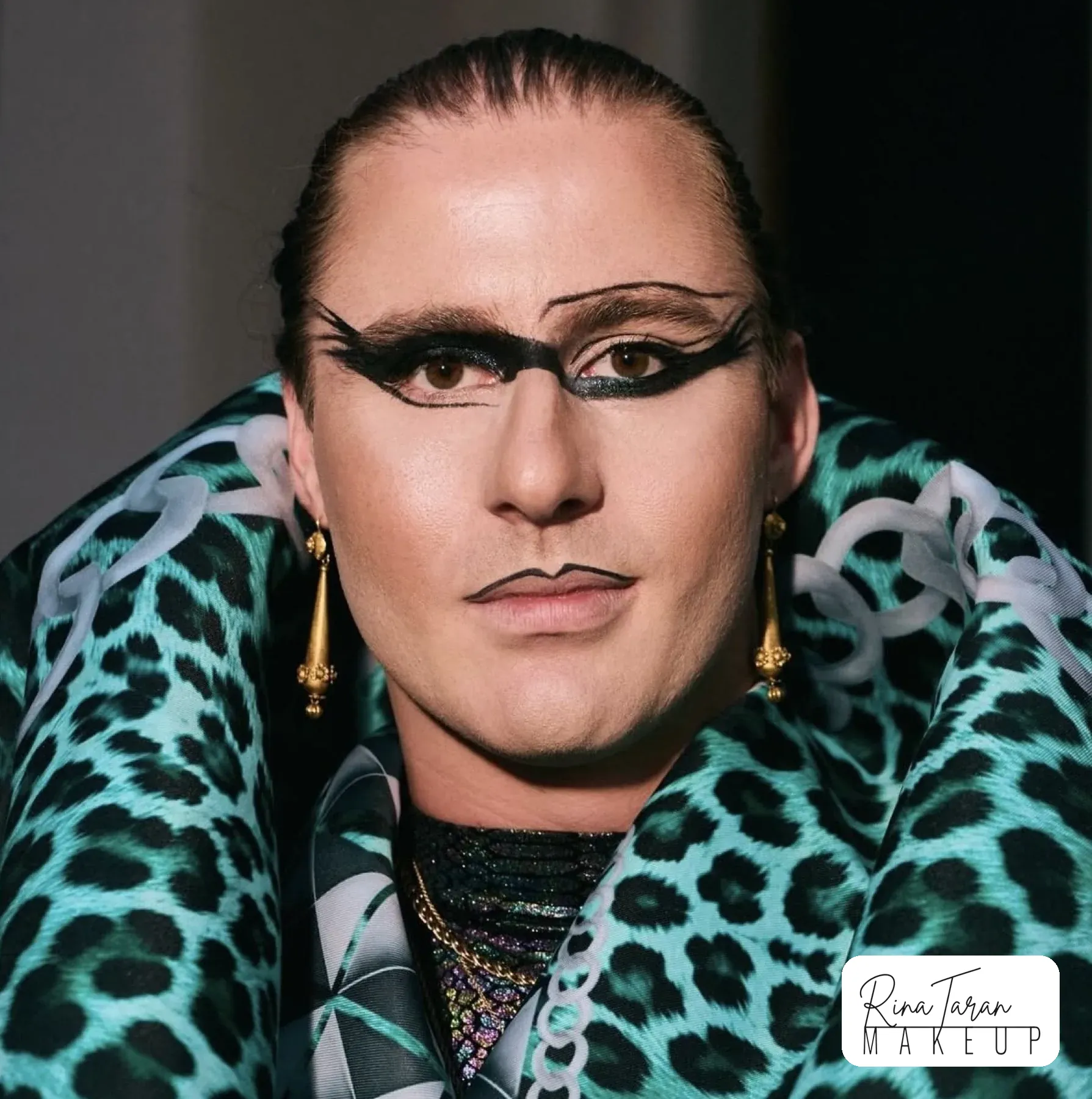 Creative graphic liner in a double wing with a pale lip, studio beauty shoot