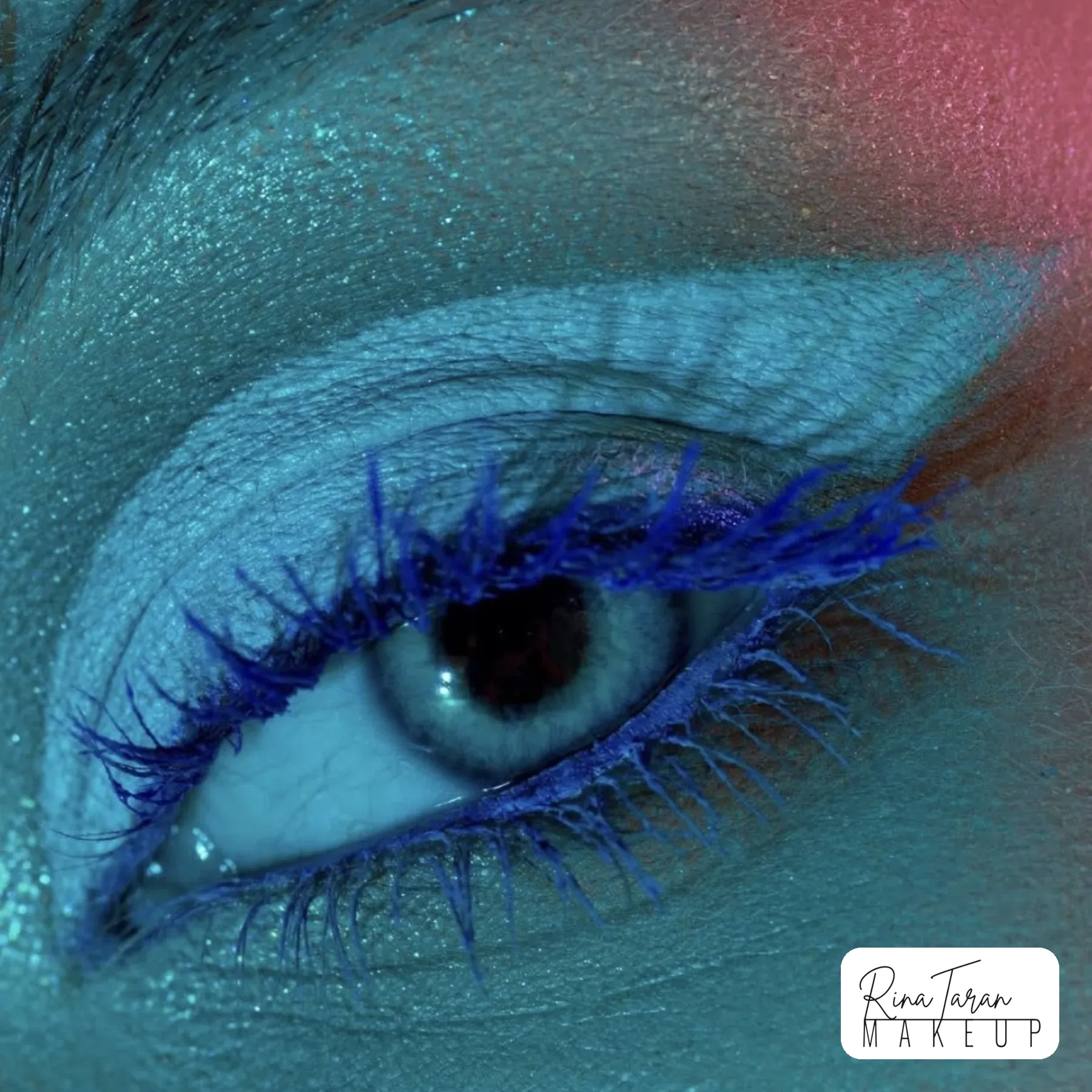 Macro beauty shot of an icy blue lid with cobalt blue mascara
