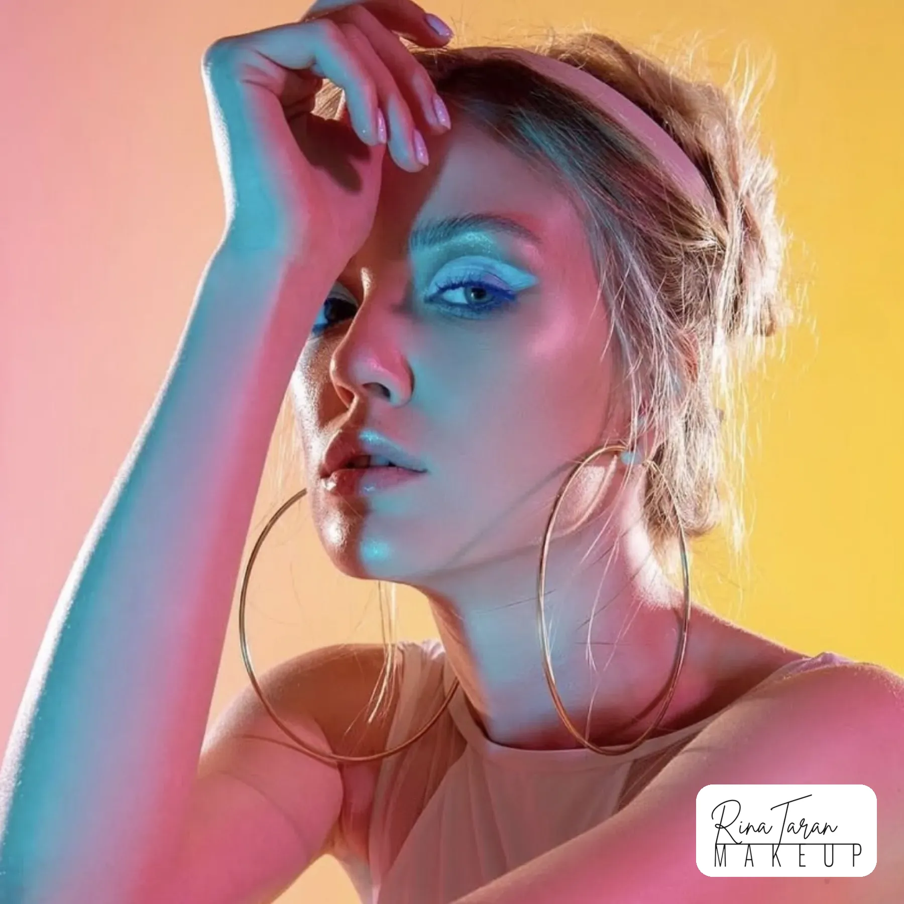 Colour gel studio shoot with blue liner and glossy skin under pink and yellow light