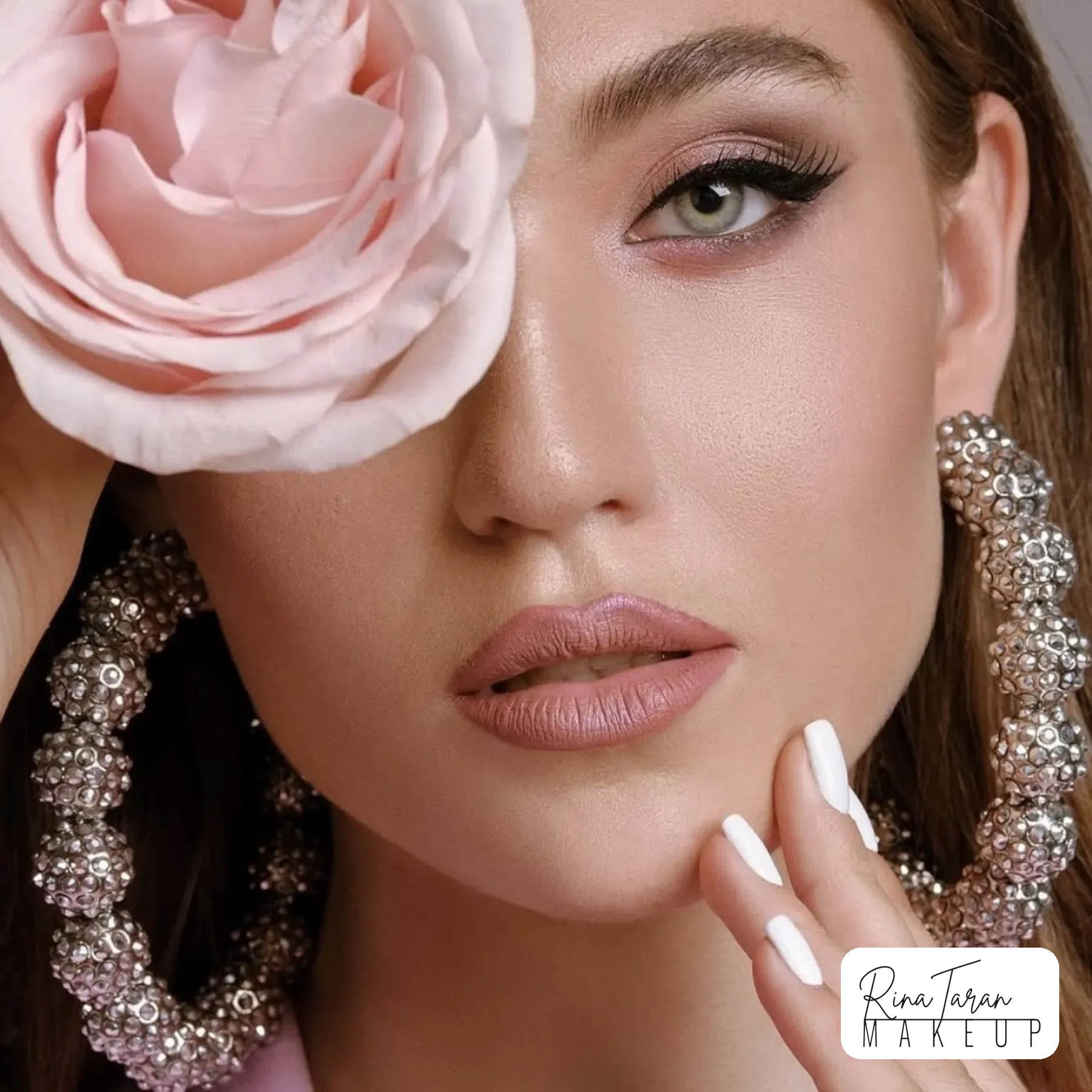 Beauty shoot with a rose over one eye, soft pink eye and a nude lip