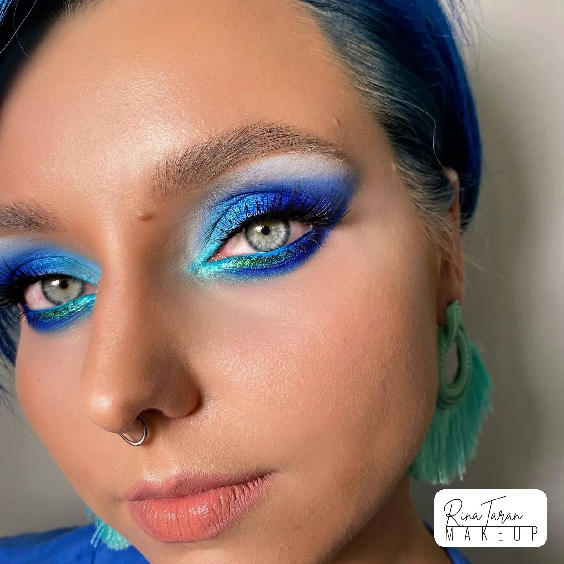 Creative colour makeup in blue and green to match blue hair
