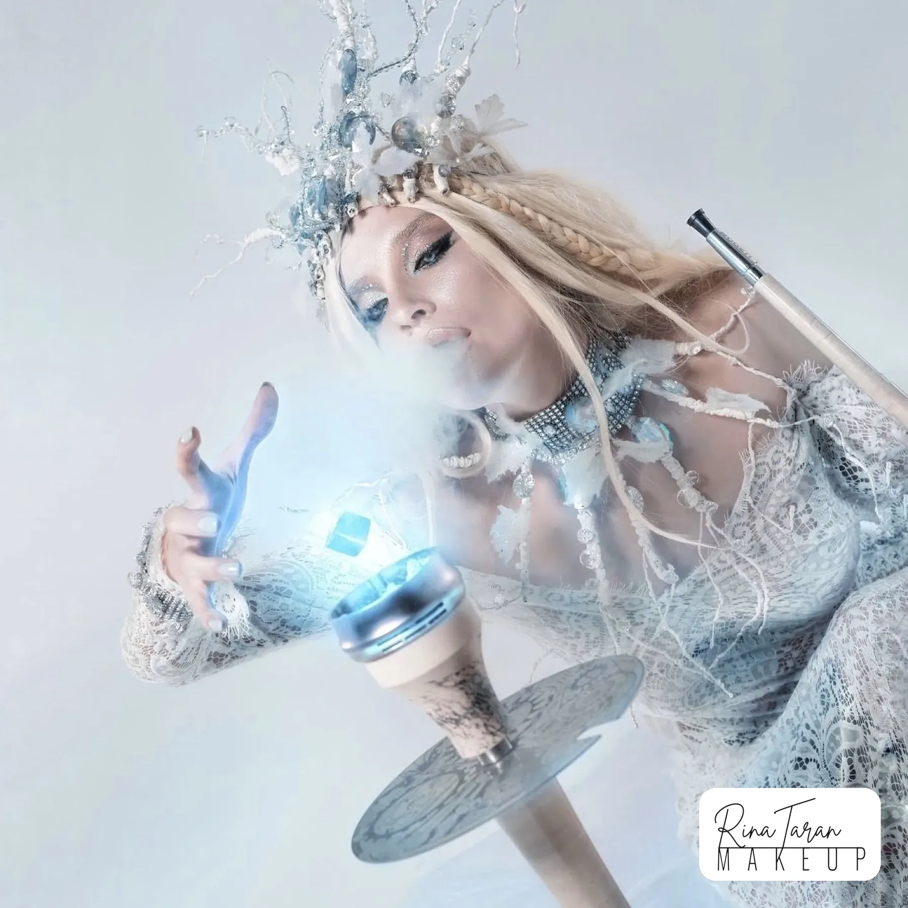 Ice queen makeup in motion with blue smoke and a silver glitter eye