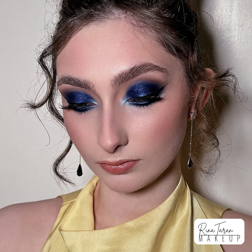 Cobalt blue smoky eye with teal shimmer through the centre and full lashes