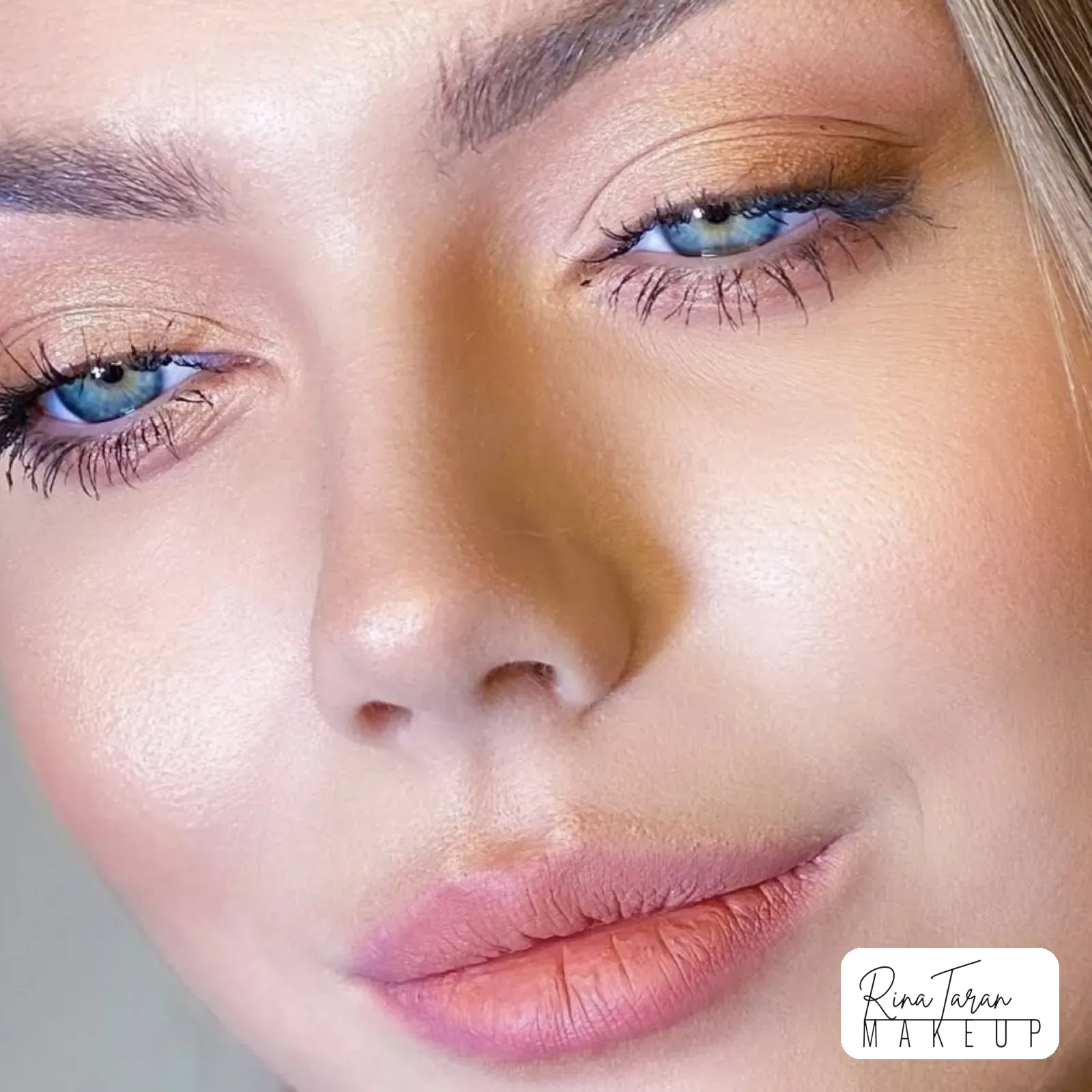 Formal makeup close up: golden shimmer on the lid, teal liner and a peach lip