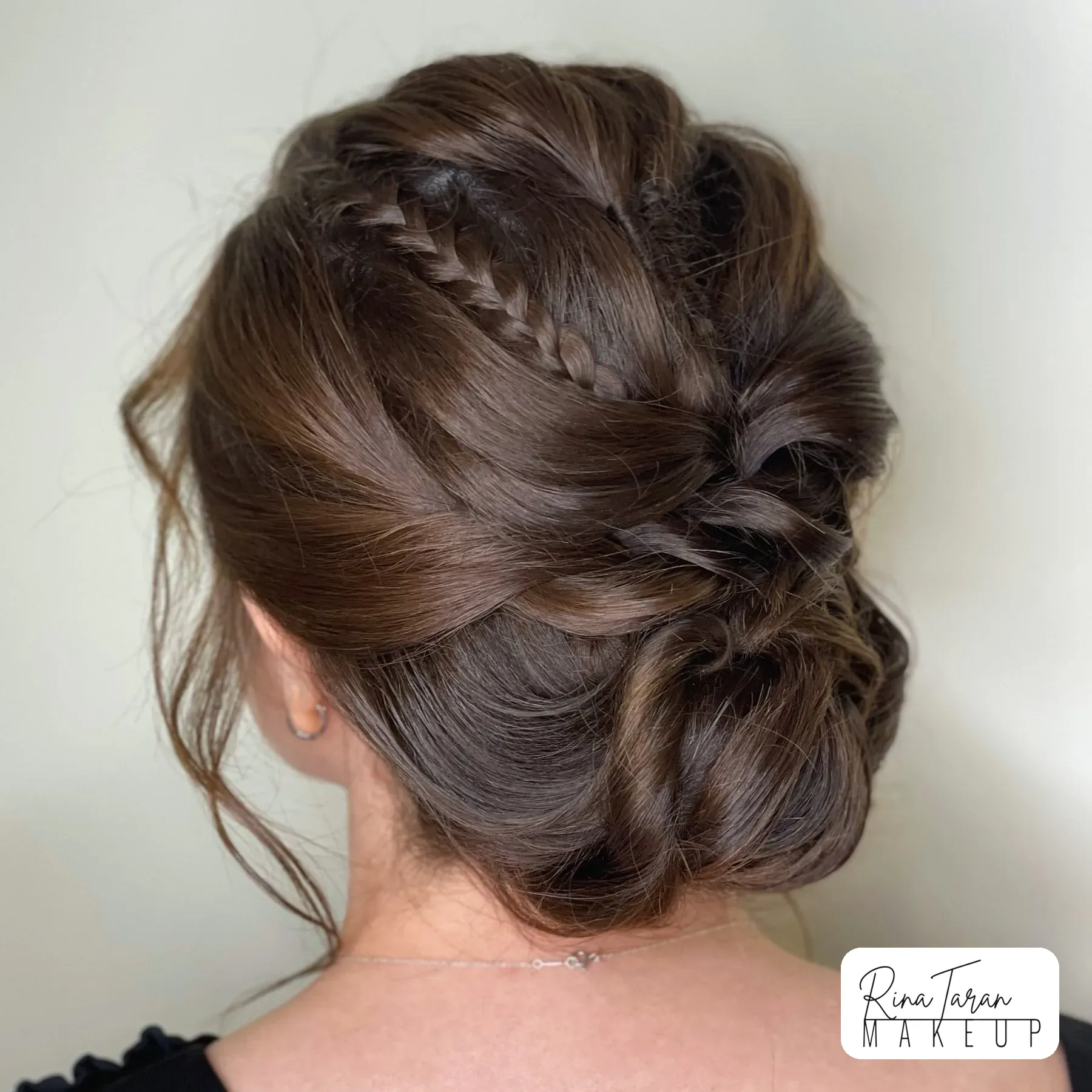 Braided low bun for a bride, pinned to hold when the wind comes off the water