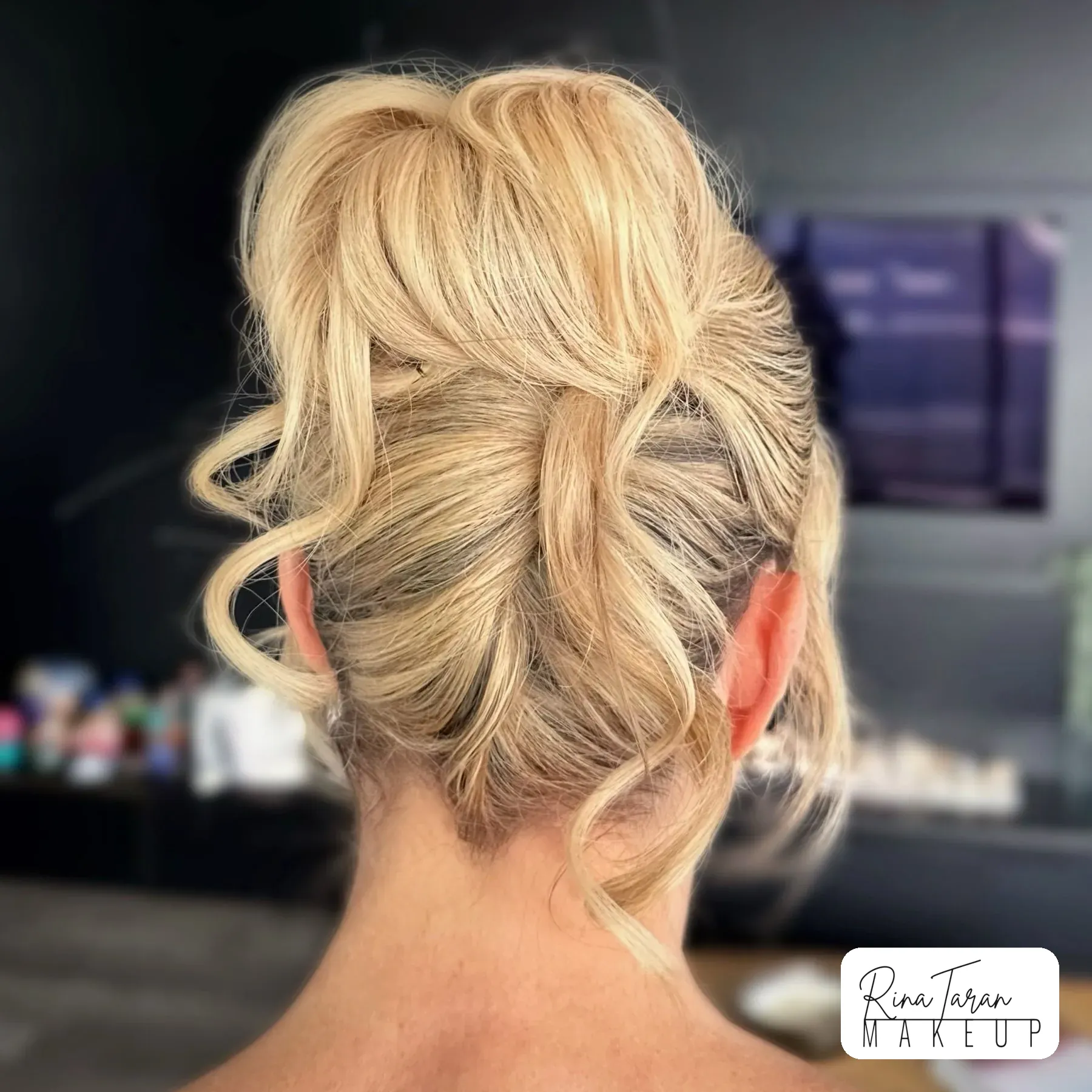 Soft French roll pinned high with face-framing tendrils left out