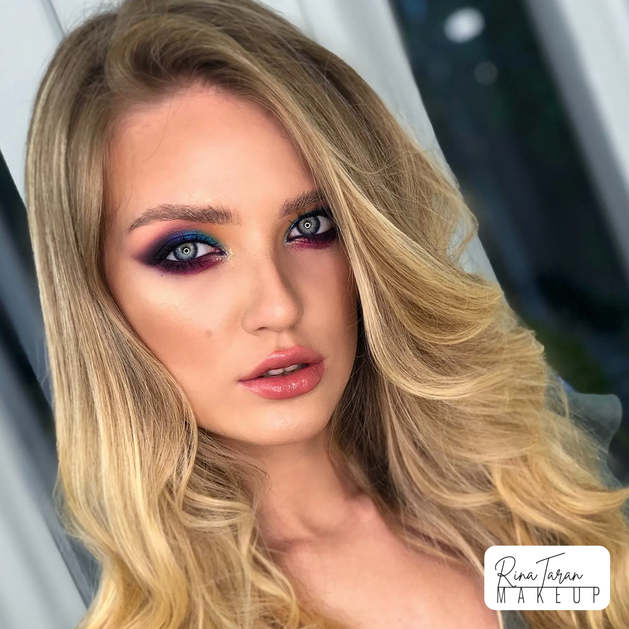 Root volume through the length with a plum and blue smoky eye, hair and makeup together