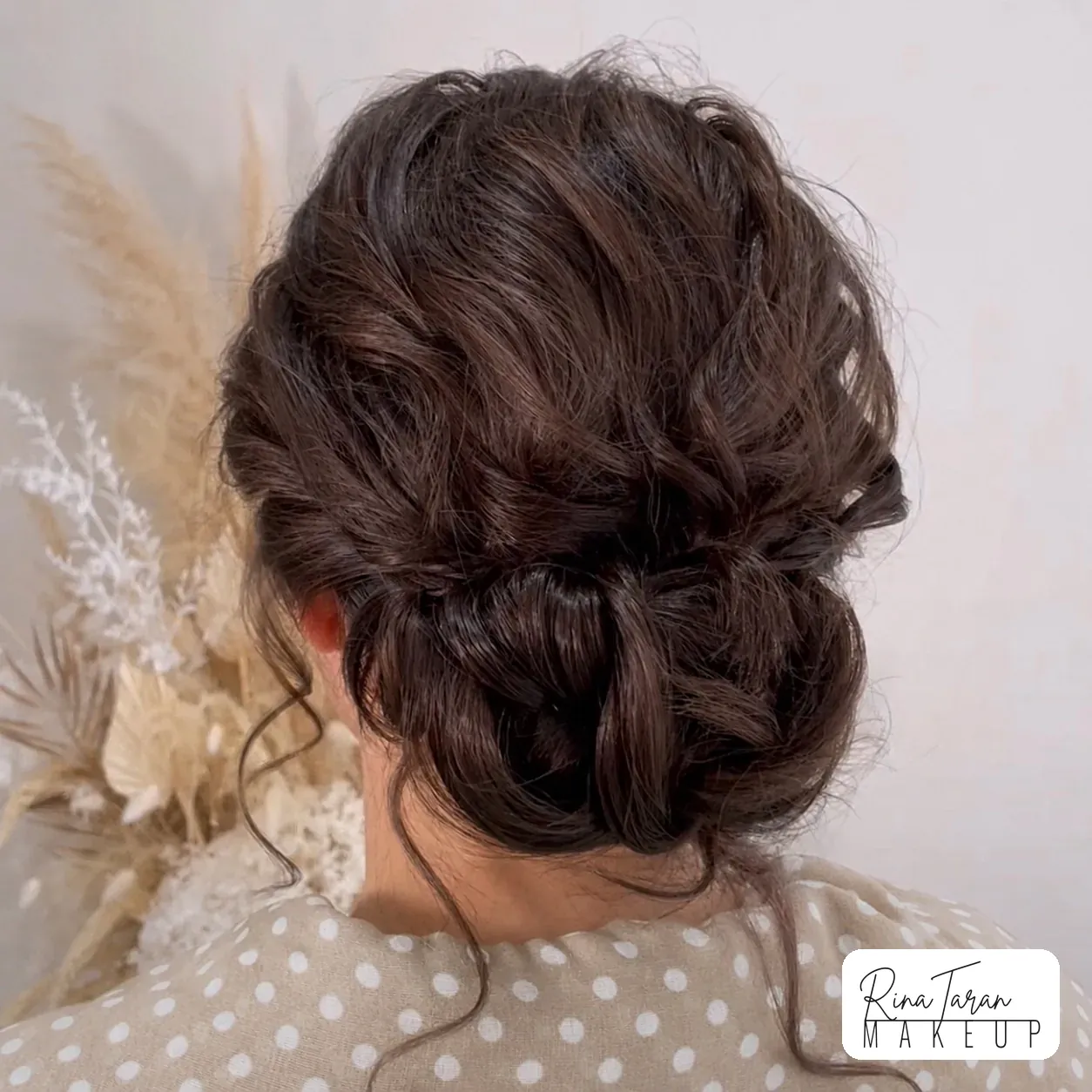 Textured updo with tendrils loose at the neck, styled for a night out