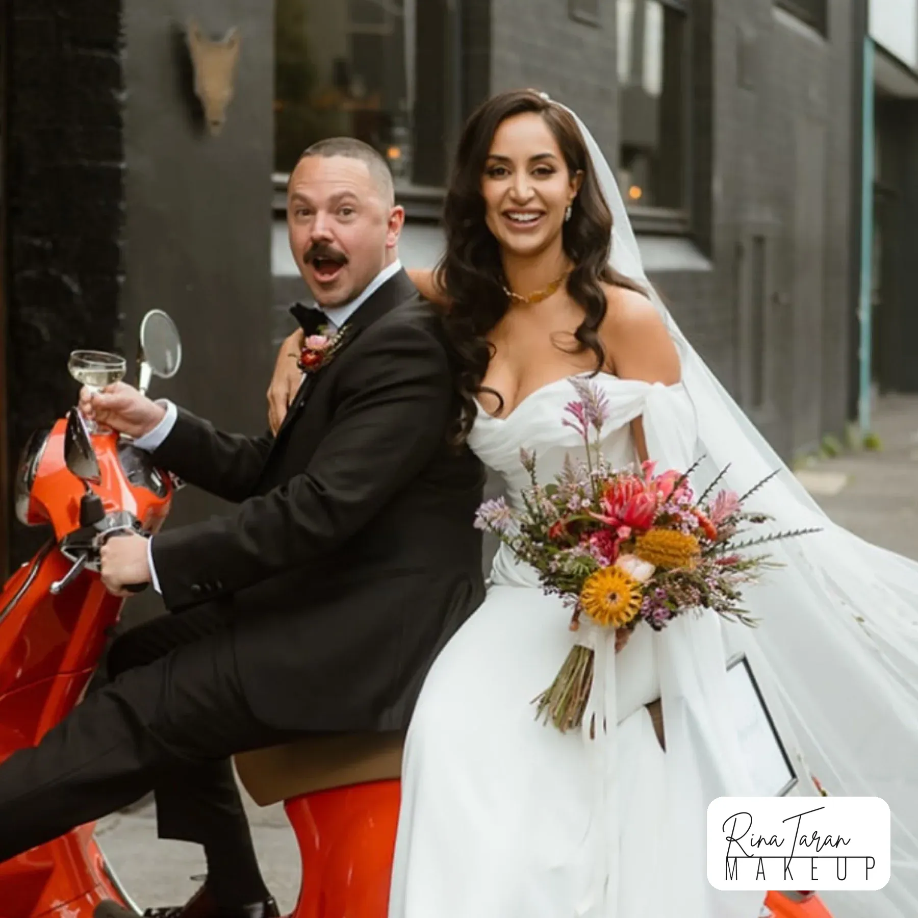 Wedding hair styling in a Melbourne laneway, veil pinned over long dark waves