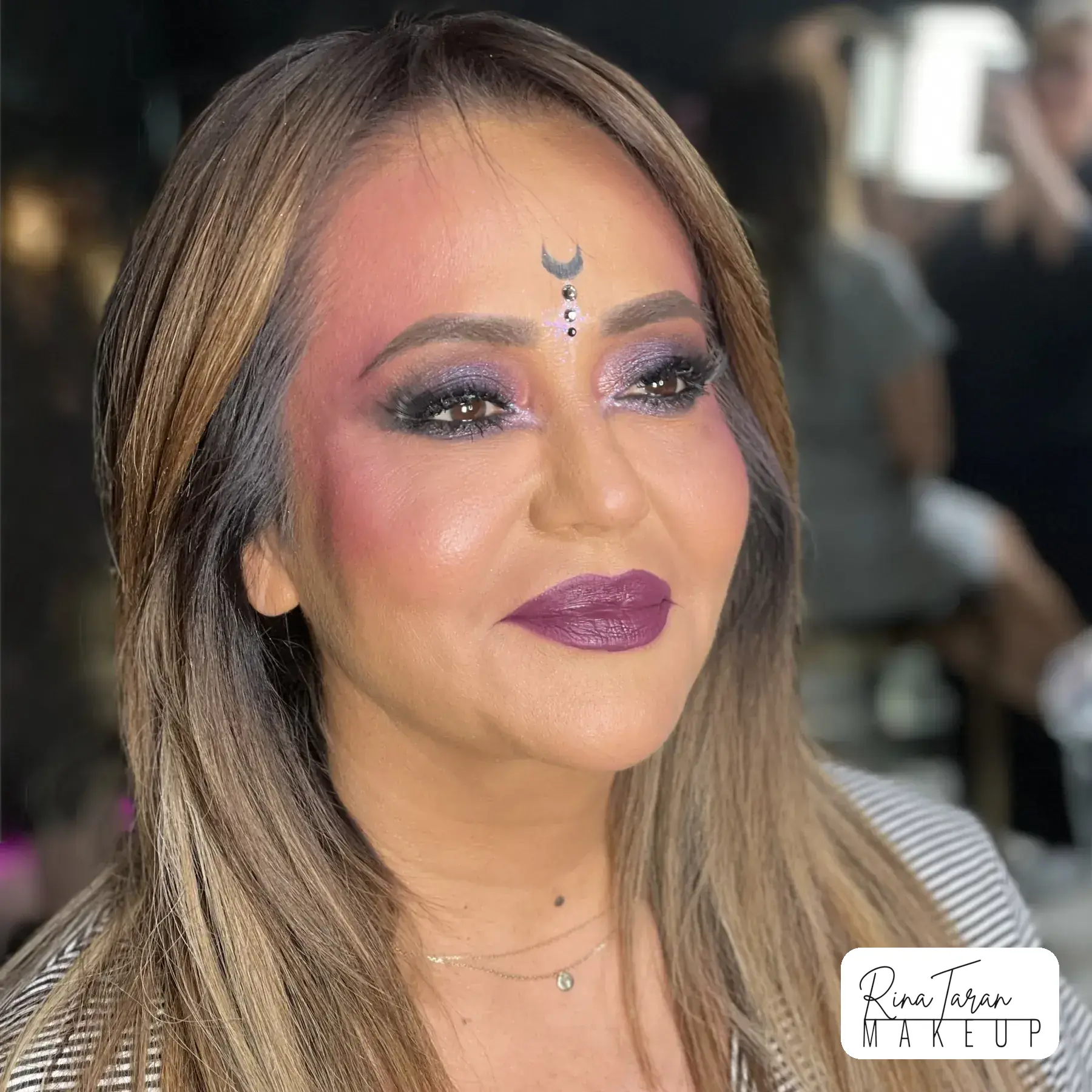 Witch makeup look kept soft, with a single painted moon at the brow