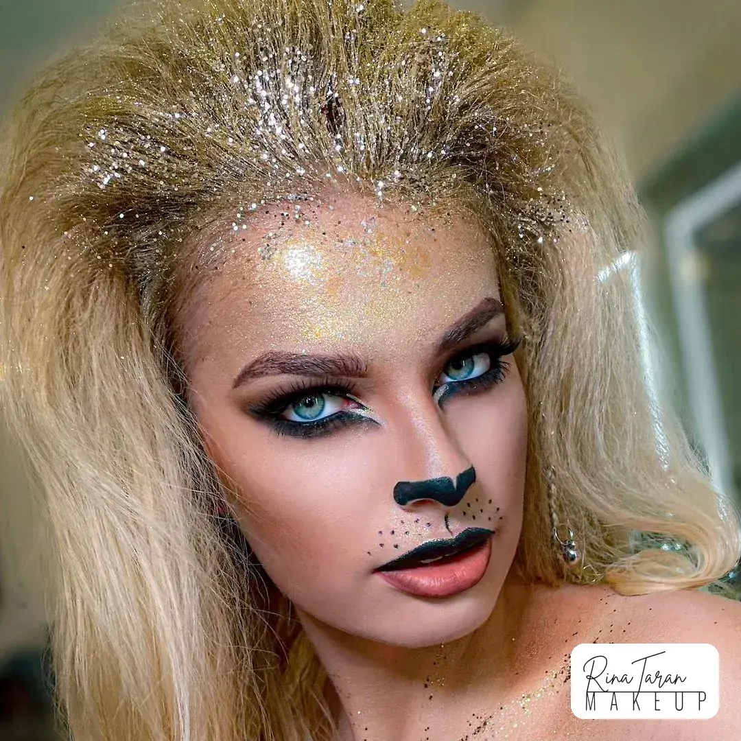 Lion makeup with glitter packed over the temples and a painted nose