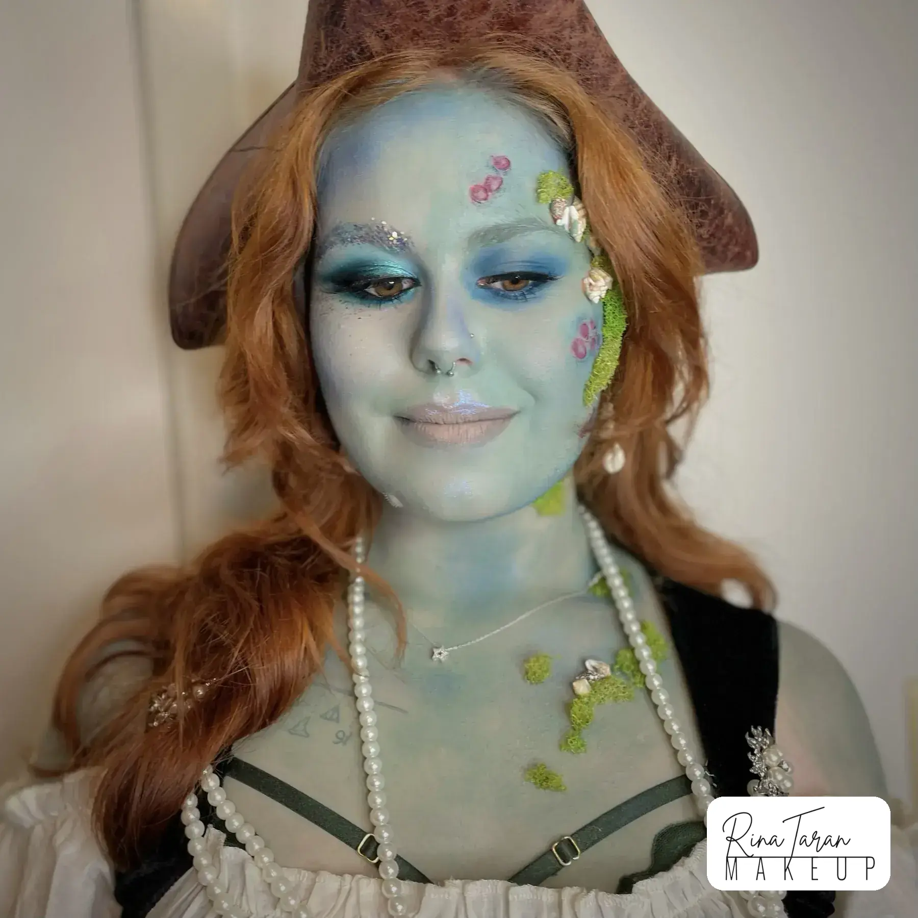 Drowned pirate makeup, a green wash over the skin with scales painted along the cheekbone