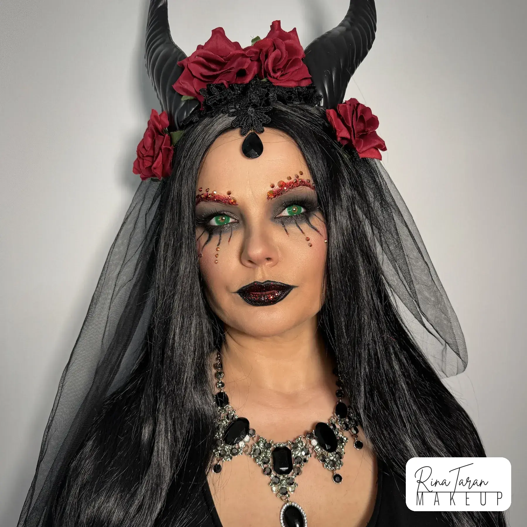 Maleficent makeup with a smoked eye, glitter tears and a matte black lip