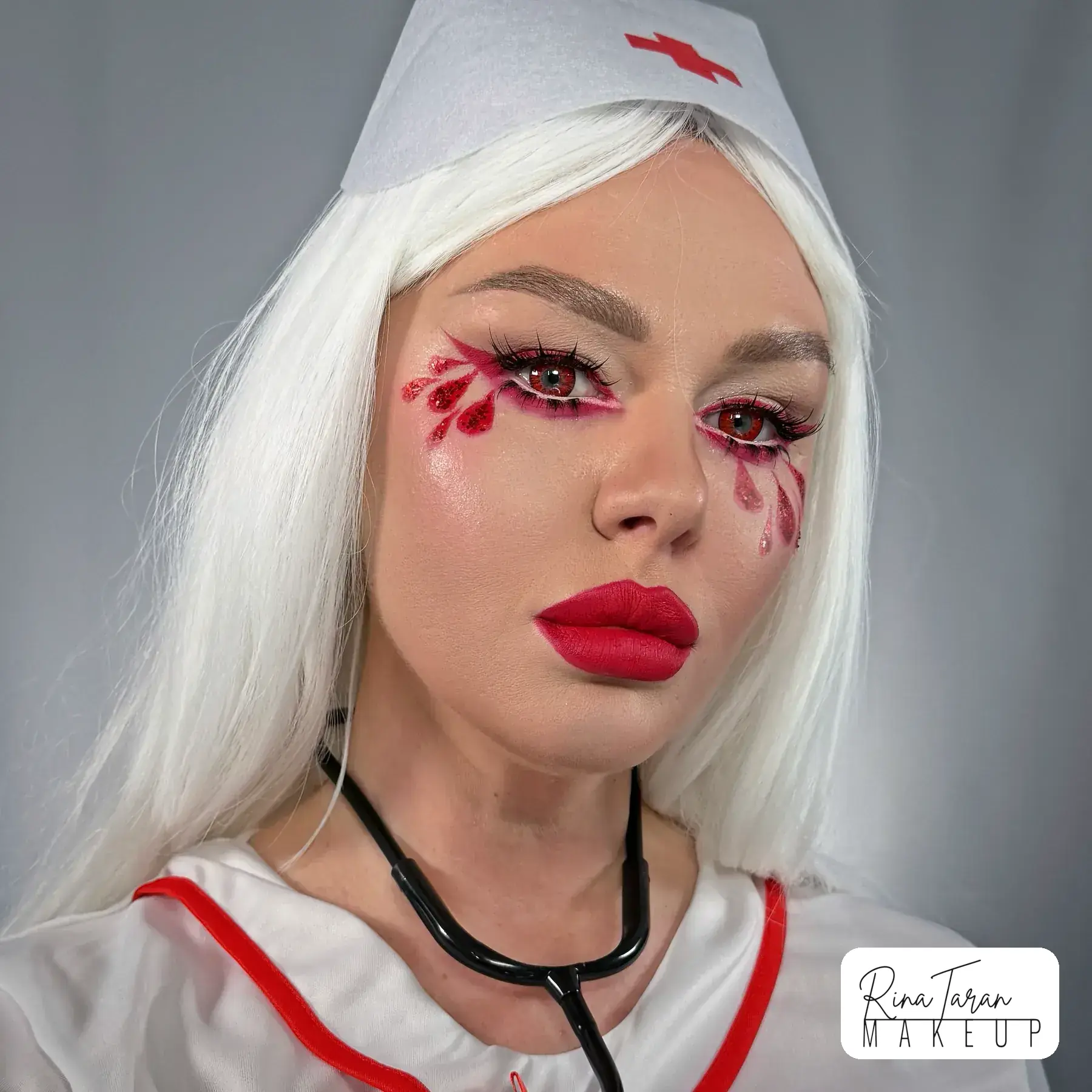 Bloody nurse makeup, a horror look with blood painted under the eyes and a bright red lip