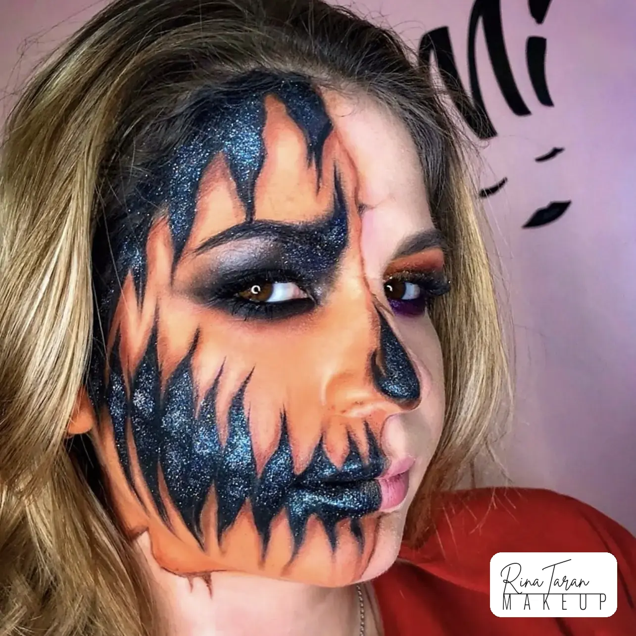 Half face pumpkin makeup in orange and glittered black, the other half left as skin