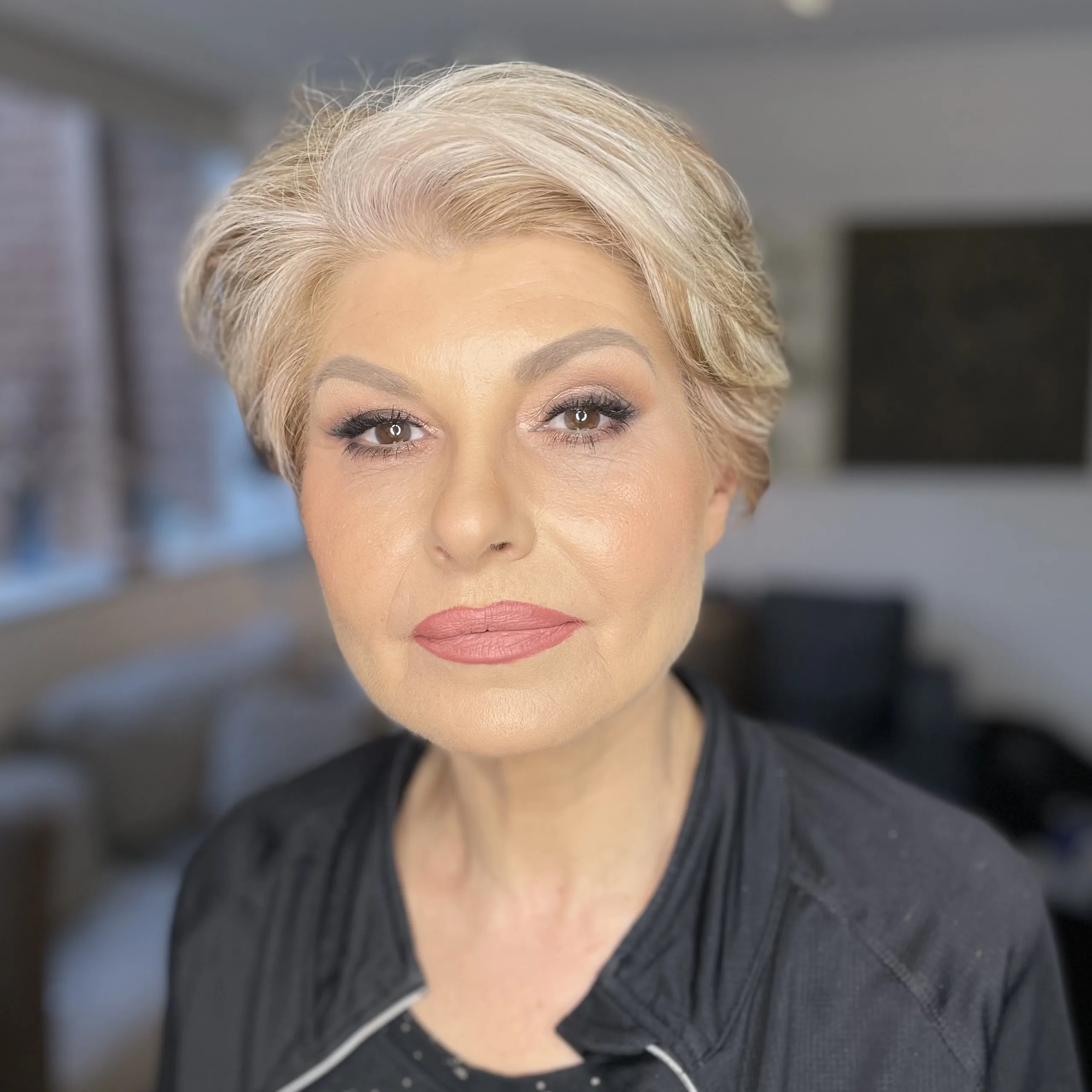 Neutral shimmer eye and a soft rose lip on short platinum blonde hair