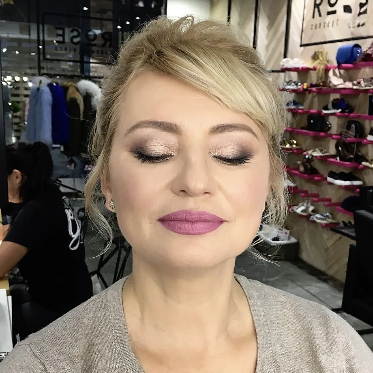 Shimmer bronze lid and a mauve lip on a blonde updo, eyes closed