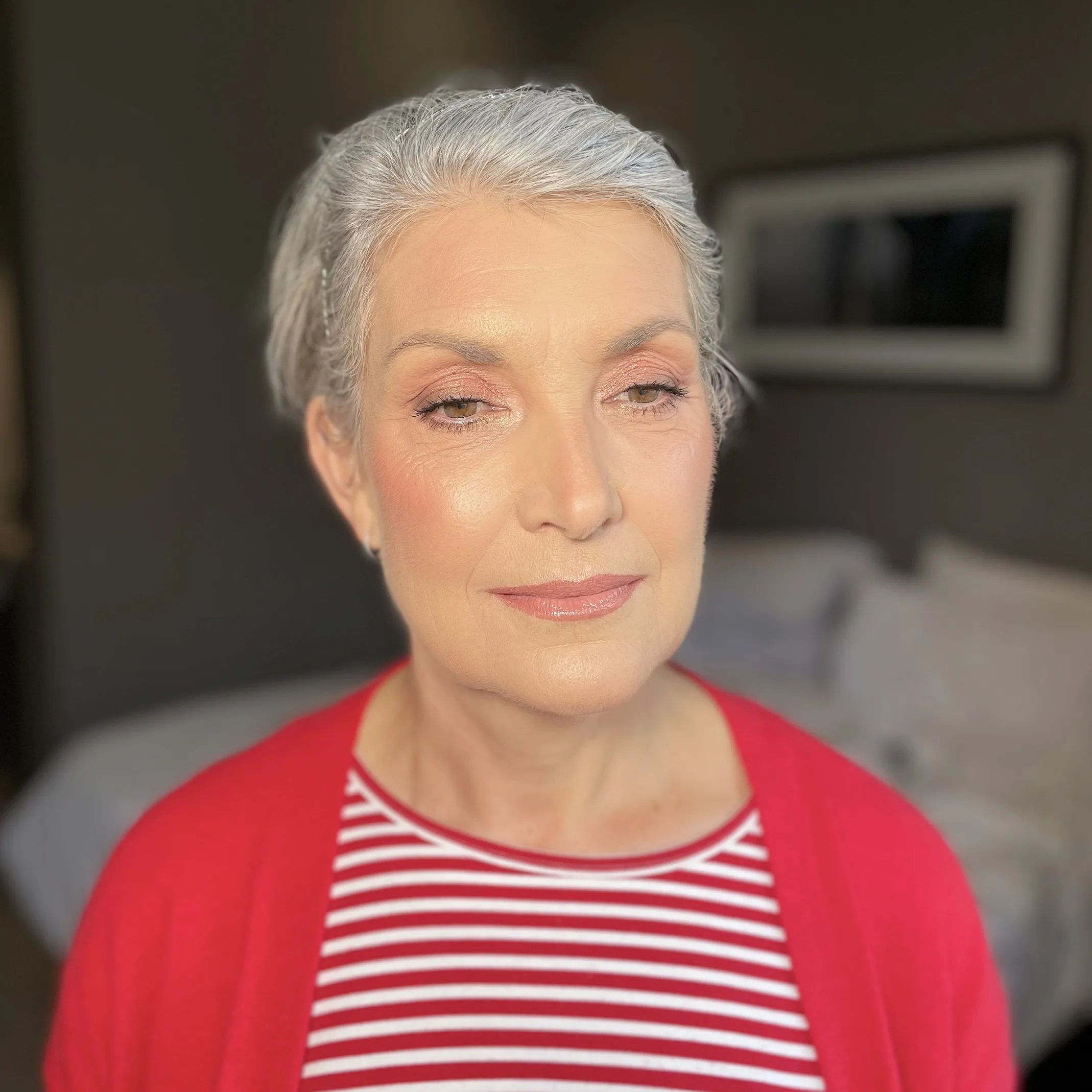 Lifted shape and glowing skin with peach shadow on silver grey hair
