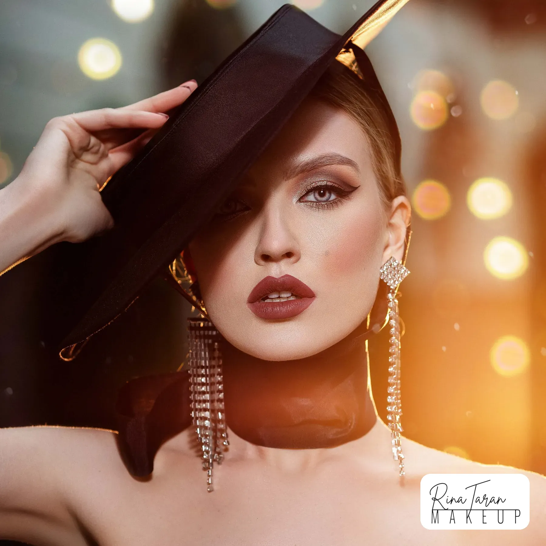A dark berry lip against a smoked bronze eye, photographed in late afternoon light