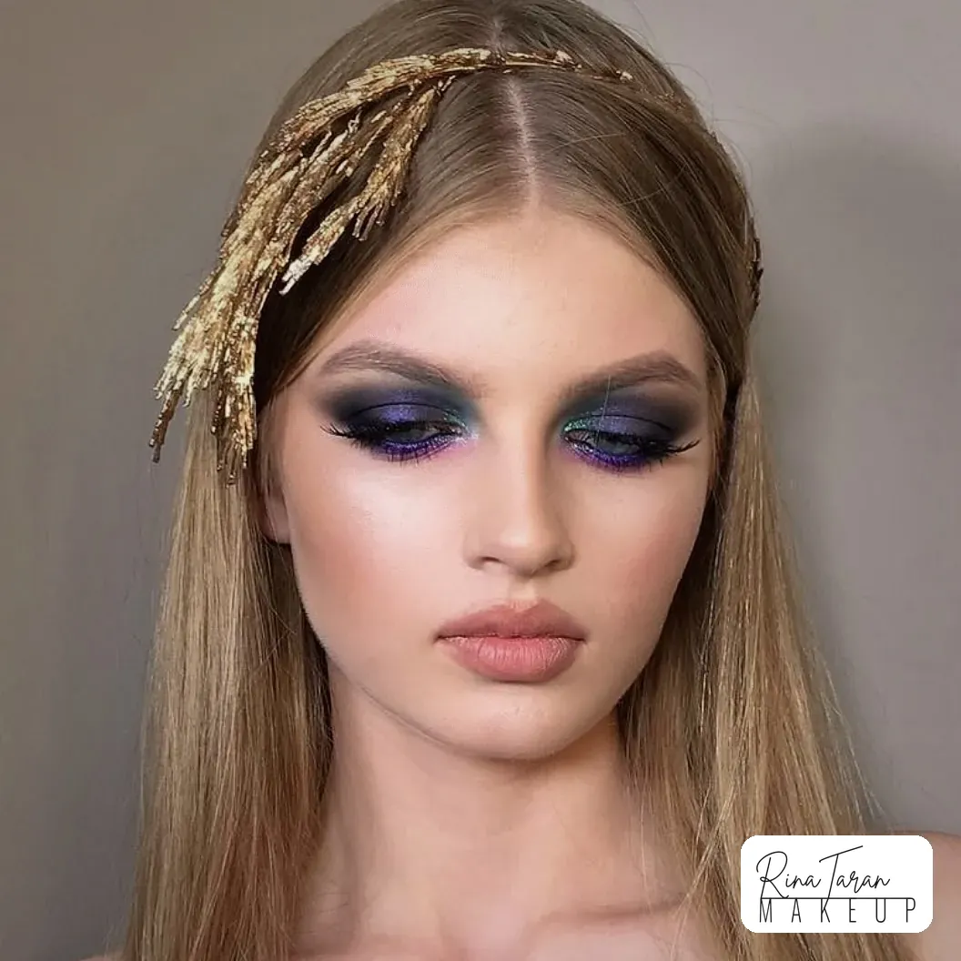 Violet glitter pressed over a deep grey smoky eye, with the lip left bare and warm