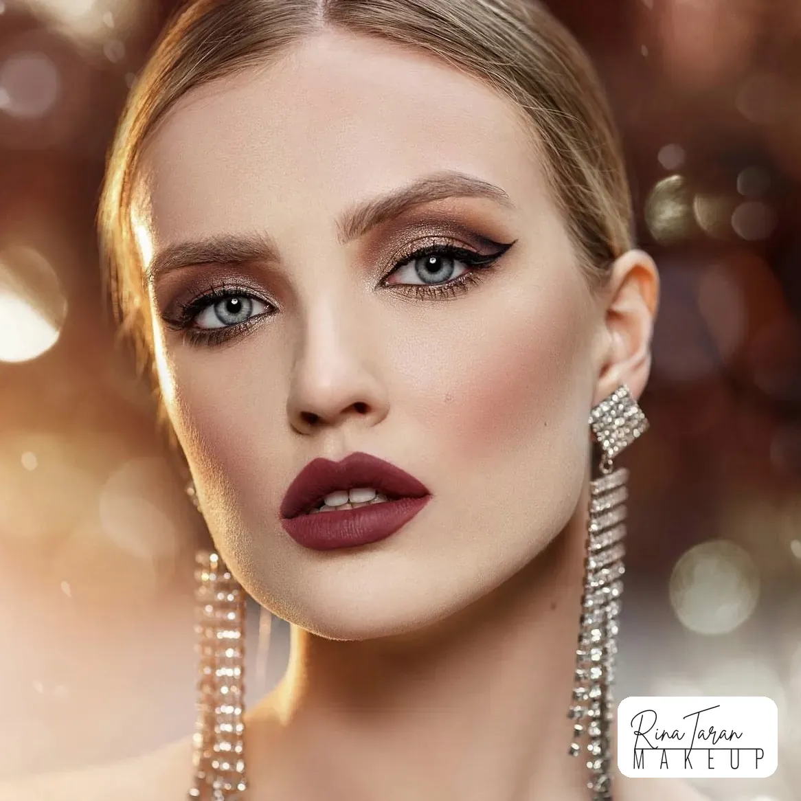 Winged liner drawn over warm bronze shadow, finished with a matte deep berry lip