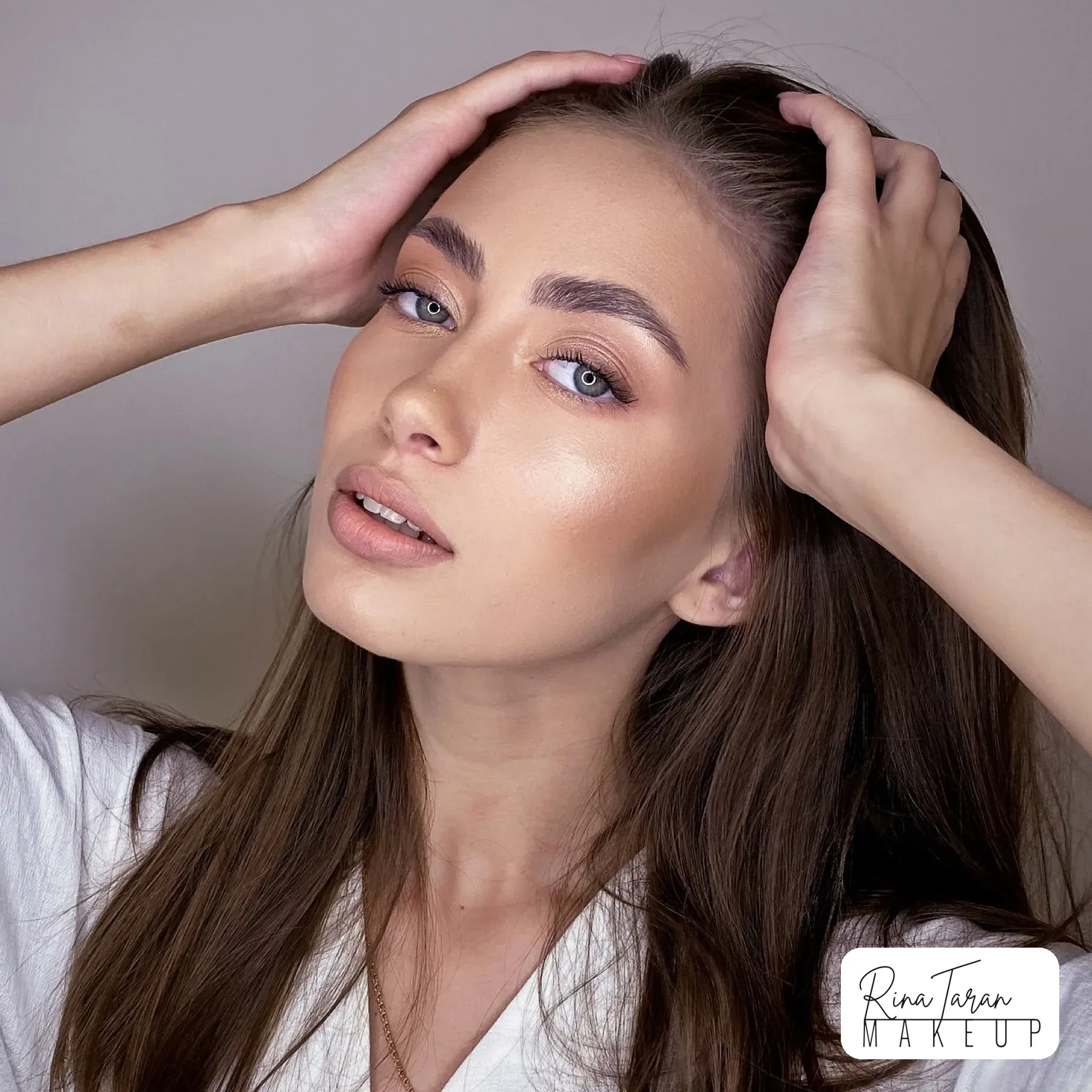 Formal makeup with brushed up brows, a lifted lash line and a bare glossy lip
