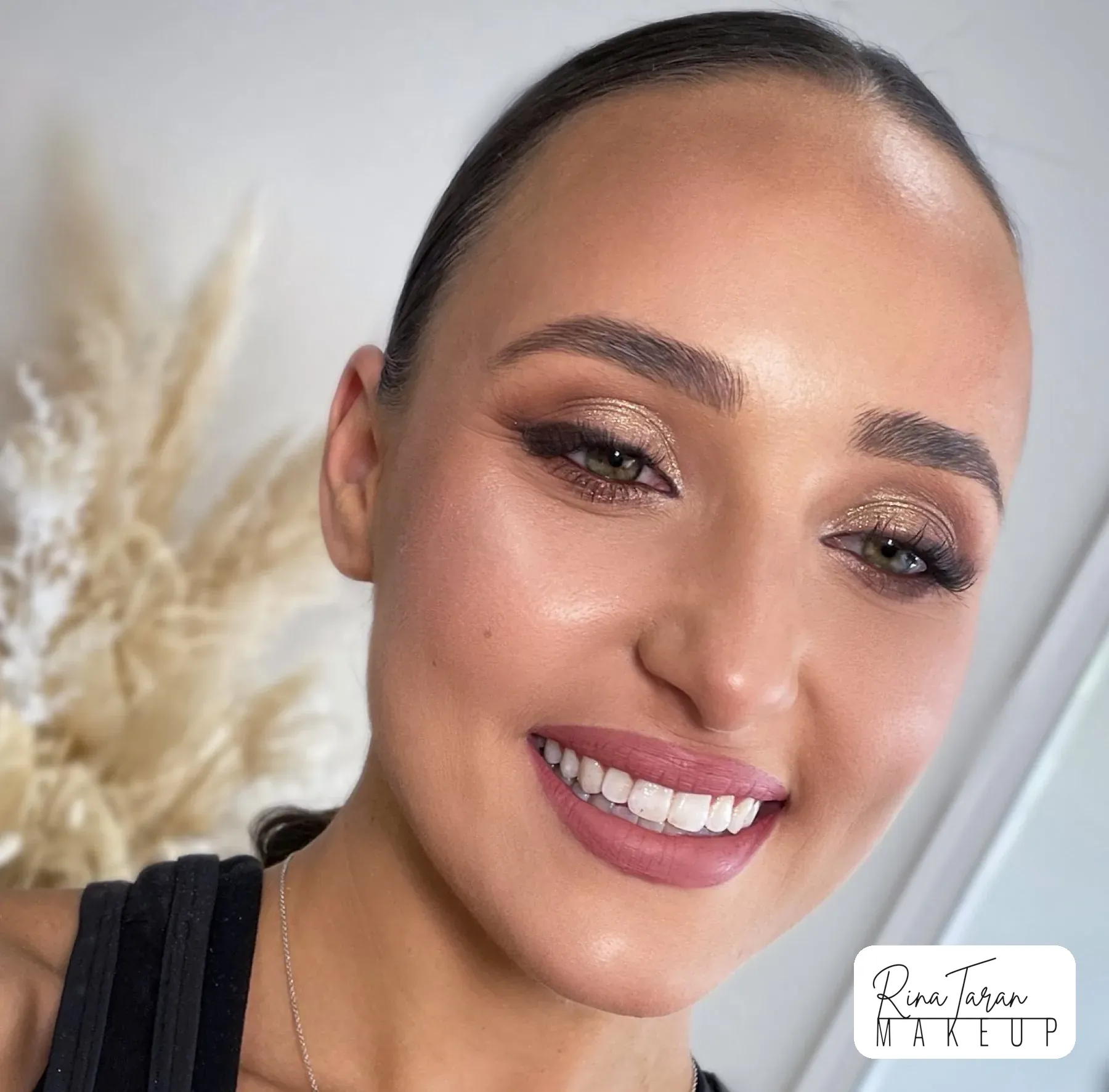 Bronze shimmer eye and a rosy lip with hair slicked back