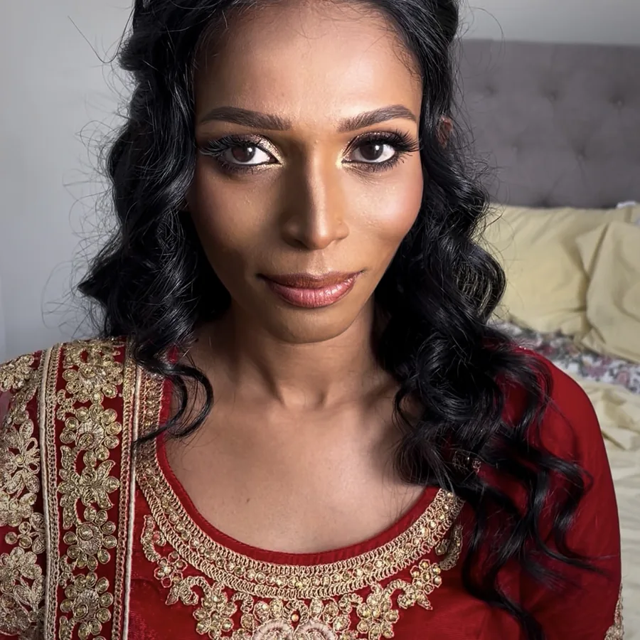 Sri Lankan bridal makeup and soft waves with a red and gold outfit