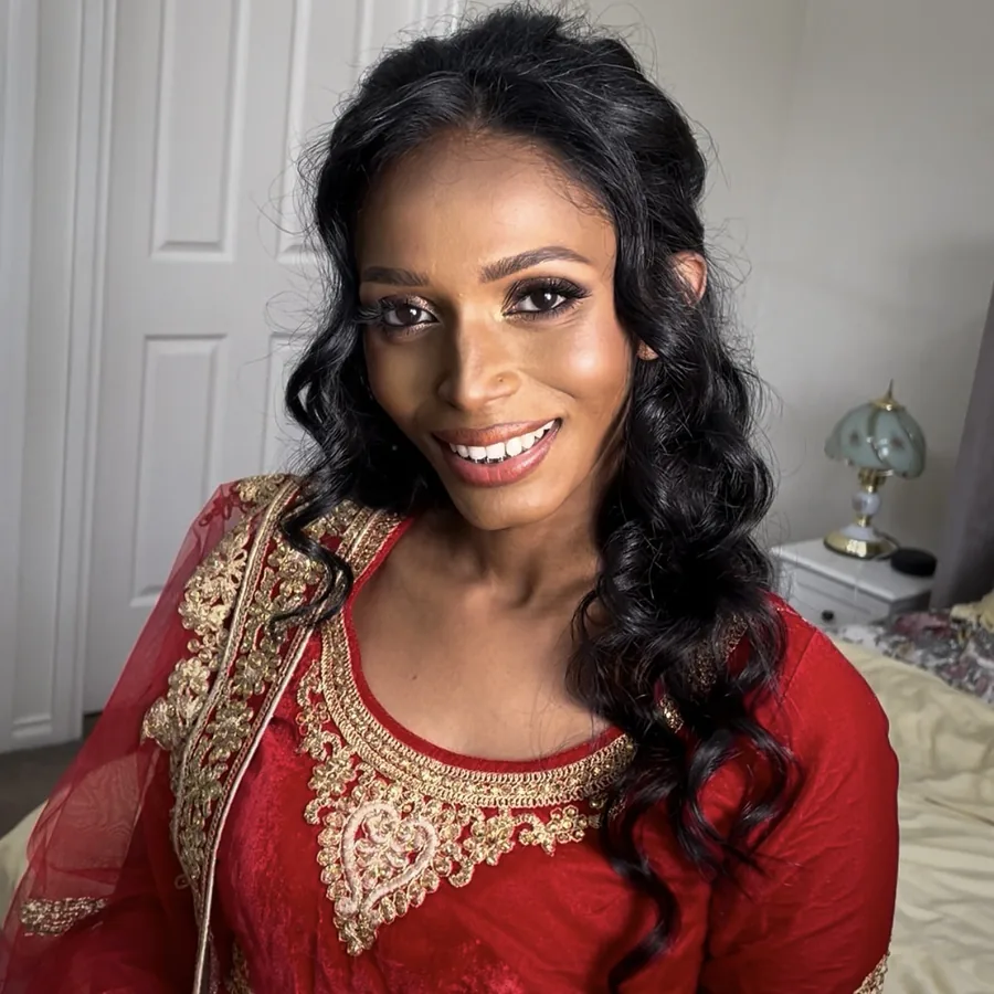 Smiling bride in red and gold, Sri Lankan wedding makeup in Melbourne